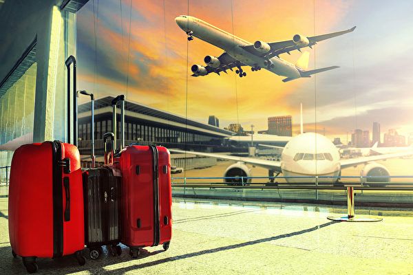 traveling luggage in airport terminal building and jet plane flying over urban scene